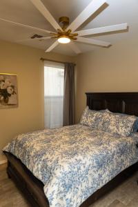 a bedroom with a bed with a ceiling fan at The Margarita in Phoenix