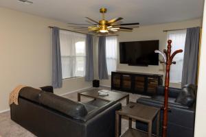 a living room with a couch and a flat screen tv at The Margarita in Phoenix