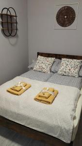a bed with two towels on top of it at Weranda in Bytom