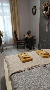 two beds with towels on them in a room at Weranda in Bytom