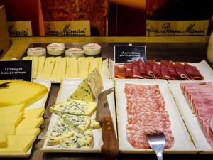 a display of different types of cheese and meats at ibis Rodez Centre in Rodez