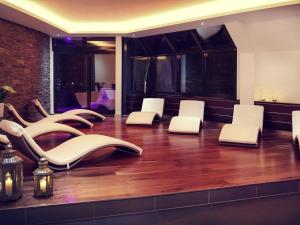 a room with white chairs and wooden floors at Mercure Hotel Hamm in Hamm