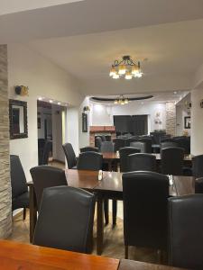a dining room with wooden tables and chairs at Hotel B dracula in Bran