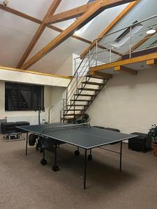 a ping pong table in a room with a staircase at Hotel B dracula in Bran +64 photos