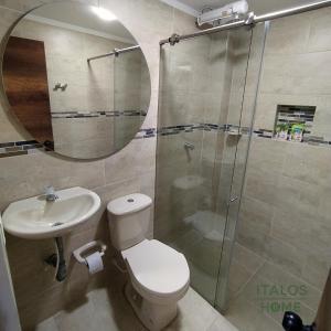 a bathroom with a toilet and a sink and a shower at Italos Home Apartamentos en Popayán in Popayan