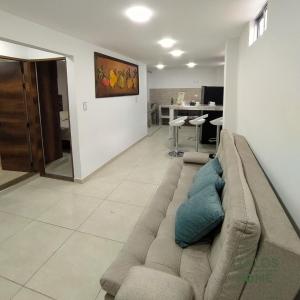 a living room with a couch and a table at Italos Home Apartamentos en Popayán in Popayan