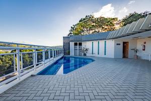a swimming pool on the balcony of a house at Bevile Hotel in Cataguases