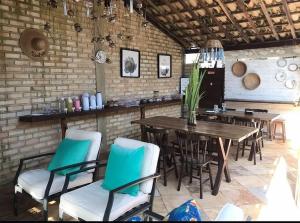 a dining room with a table and chairs at Pousada Ventoria in Canguaretama