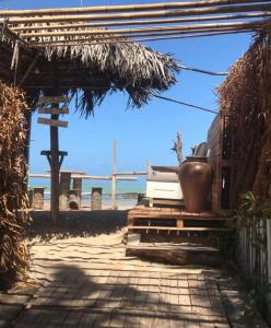 a patio with a bench and a view of the ocean at Pousada Ventoria in Canguaretama