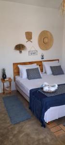 a bedroom with two beds and a table at Pousada Ventoria in Canguaretama +11 photos
