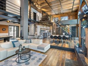 a living room with a couch and a table at Vue panoramique Spa Moderne in Sainte-Lucie-de-Doncaster +33 photos