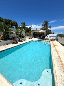 a swimming pool in a resort with blue water at Casa Alta PR in Santa Maria