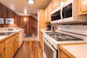 a kitchen with white appliances and wooden cabinets at Creekside Chalet Stay for 6 in Kings Beach +39 photos