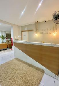 a lobby with a reception counter with a rug at Pousada Serra Bella in Tianguá +82 photos