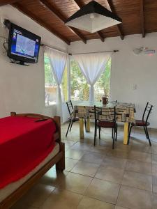 ein Schlafzimmer mit einem Tisch und einem TV an der Wand in der Unterkunft Aneley Cabañas Bosque Peralta Ramos in Mar del Plata