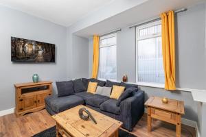 a living room with a couch and a table at Stockton Town centre en-suite rooms in Stockton-on-Tees