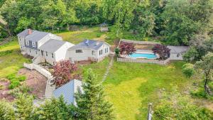 an aerial view of a house with a swimming pool at Woodhaven Reserve by STREAM in Purcellville