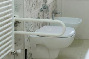 a bathroom with a toilet and a sink at Bed & Breakfast L'Albero Maestro in Borgofranco dʼIvrea +42 photos