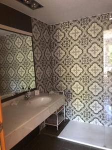 a bathroom with a tub and a sink and a wallpaper at Standing Apartment Barcelona Forum in Sant Adria de Besos +26 photos