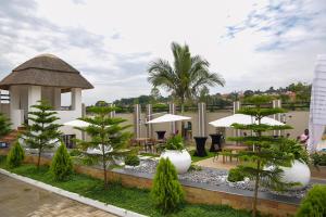 a view of a resort with trees and umbrellas at Mileleishome in Buwate