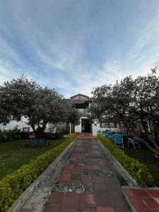 a walkway with trees in front of a building at Suite del hotel Blau in Sopo +9 photos
