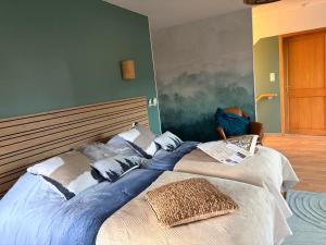 a bedroom with a large bed with pillows on it at Gîte le Nid in Uffholtz