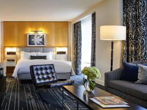 a hotel room with a bed and a couch at Sofitel Chicago Magnificent Mile in Chicago