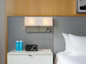 a hotel room with a bed and a clock on a wall at Sofitel Chicago Magnificent Mile in Chicago +157 photos