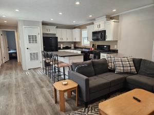 a living room with a couch and a kitchen at West Battle Lake w Lake Views in Battle Lake