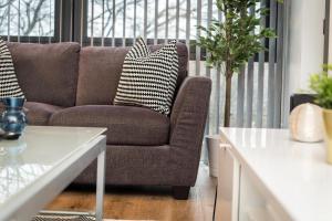 a living room with a couch and a table at Central Modern 2BR Flat with Parking & Balcony in Liverpool