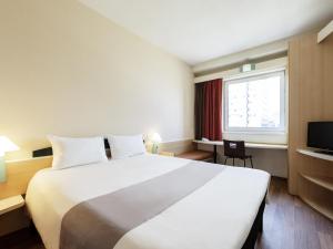 a hotel room with a large bed and a window at Hotel Ibis Łódź Centrum in Łódź +59 photos