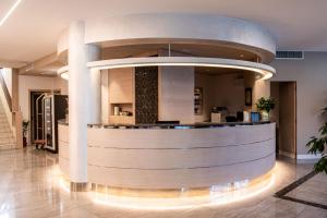 a lobby with a bar in a building at Hotel Olimpia in Imola