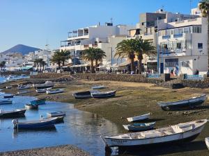 a group of boats on the shore of a beach at Ático Monarca II in Arrecife