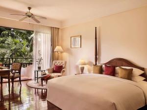 a bedroom with a large bed and a balcony at Sofitel Angkor Phokeethra Golf & Spa Resort in Siem Reap