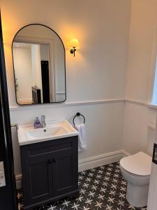 a bathroom with a sink and a mirror and a toilet at An Chill Bheag At the Blessington Lakes in Blessington +20 photos