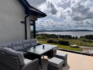 a patio with a table and chairs and a view of a lake at An Chill Bheag At the Blessington Lakes in Blessington