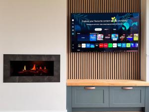 a tv and a fireplace in a room at An Chill Bheag At the Blessington Lakes in Blessington