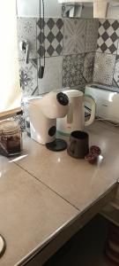 a kitchen counter with a mixer and a cup at Loft Moderno in Viedma