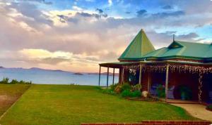 a house on a hill with a view of the mountains at Blue Haven Beach House - Guest Suite I  +9 photos