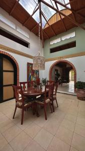 a dining room with a table and chairs and a chandelier at Casa Amaru in Guarne