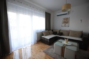 a living room with a couch and a table at Stan na dan Luna in Smederevska Palanka