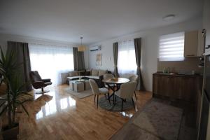 a kitchen and a living room with a table and chairs at Stan na dan Luna in Smederevska Palanka