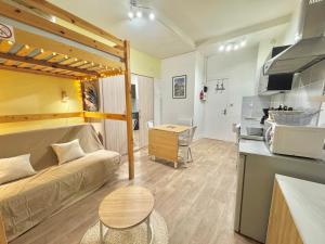 a small living room with a couch and a kitchen at Studio le Desman des Neiges - Hyper centre - Proche thermes et télécabine in Cauterets +8 photos