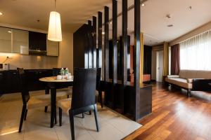 a kitchen and living room with a table and chairs at Resort Suites at Bandar Sunway in Petaling Jaya