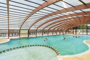 a large swimming pool with people in the water at Val'B ocean-bord de plage in Sarzeau
