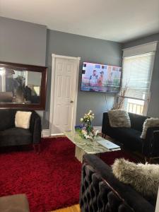 a living room with two couches and a tv at Woodbridge Heritage Home in Vaughan