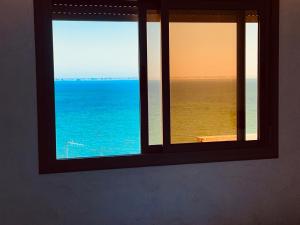 a window with a view of the ocean at Heart of Dakhla Residence in Dakhla