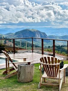 2 sillas sentadas en una terraza con vistas a la montaña en Vista espetacular, piscina e banheira no quarto!, en Maria da Fé 37 fotos más