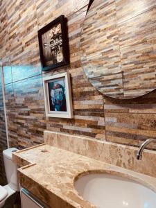 a bathroom with a large sink and a mirror at Portuá Chalés in São Miguel dos Milagres +101 photos