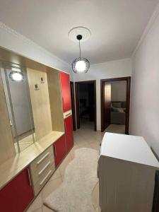 a kitchen with red cabinets and a white counter top at Crystal Heart Fier in Fier